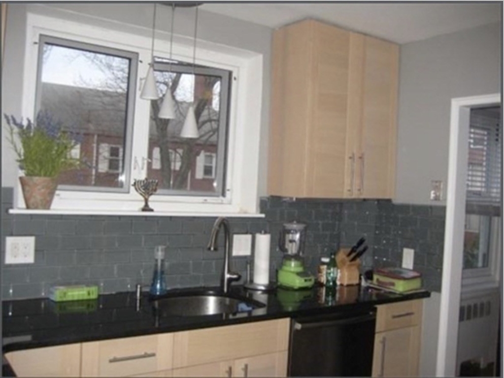 136 Boylston Street, Unit 1 Newton, MA 02467 - Photo 10 of 21 a kitchen with a sink and cabinets