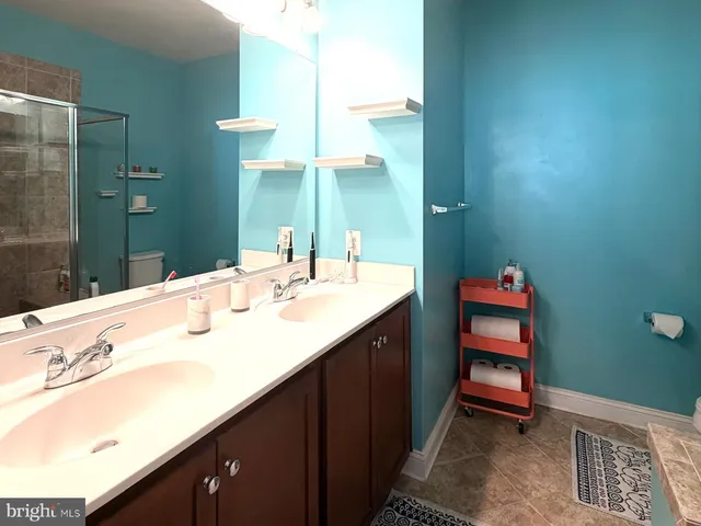 a bathroom with a sink double vanity and a mirror