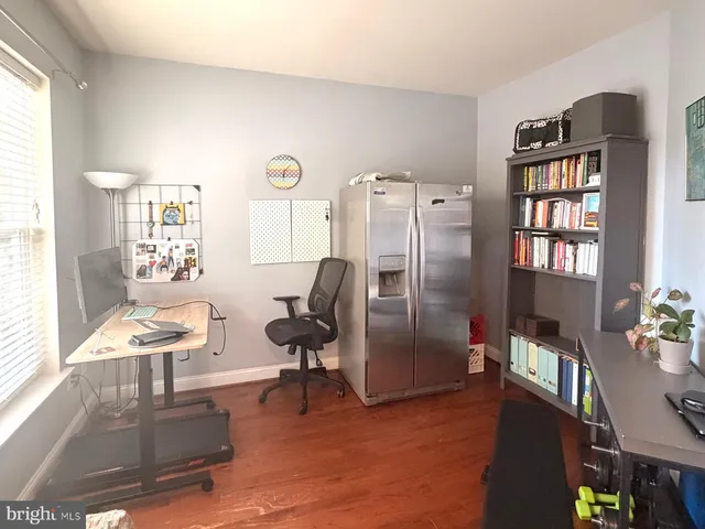 a living room with furniture wooden floor and a window