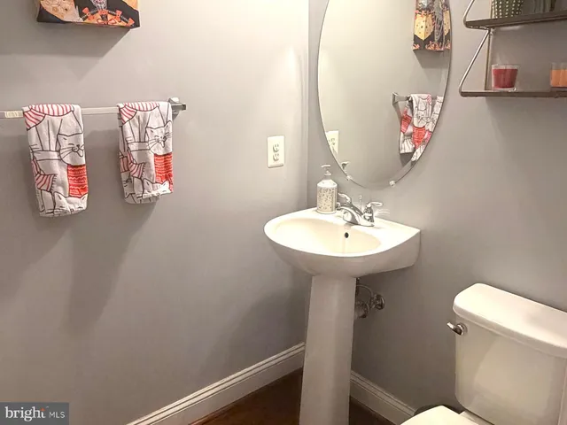 a bathroom with a sink a mirror and toilet