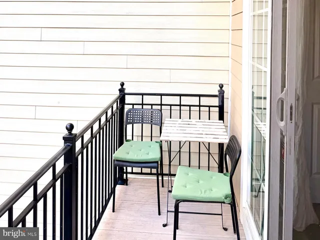 a view of a porch with furniture and wooden floor