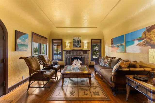 a living room with furniture a rug and a floor to ceiling window