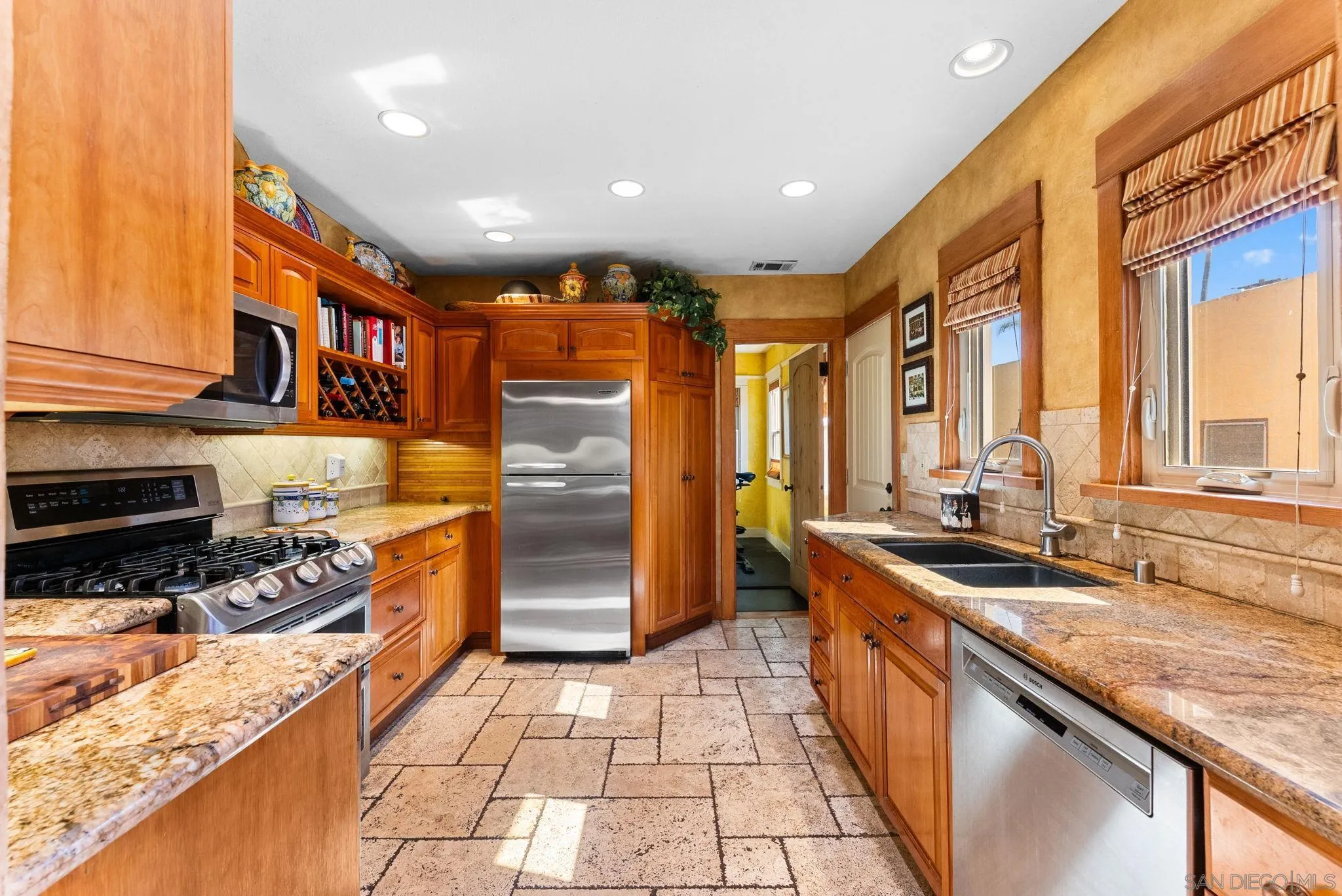 4965 Marlborough Drive San Diego, CA 92116 - Photo 10 of 47 a kitchen with stainless steel appliances granite countertop a sink stove and cabinets