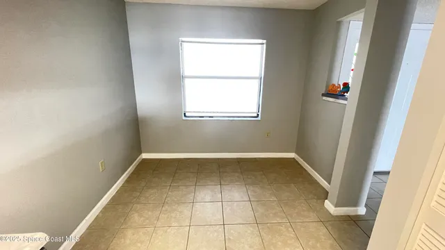 a view of room with window and wooden floor