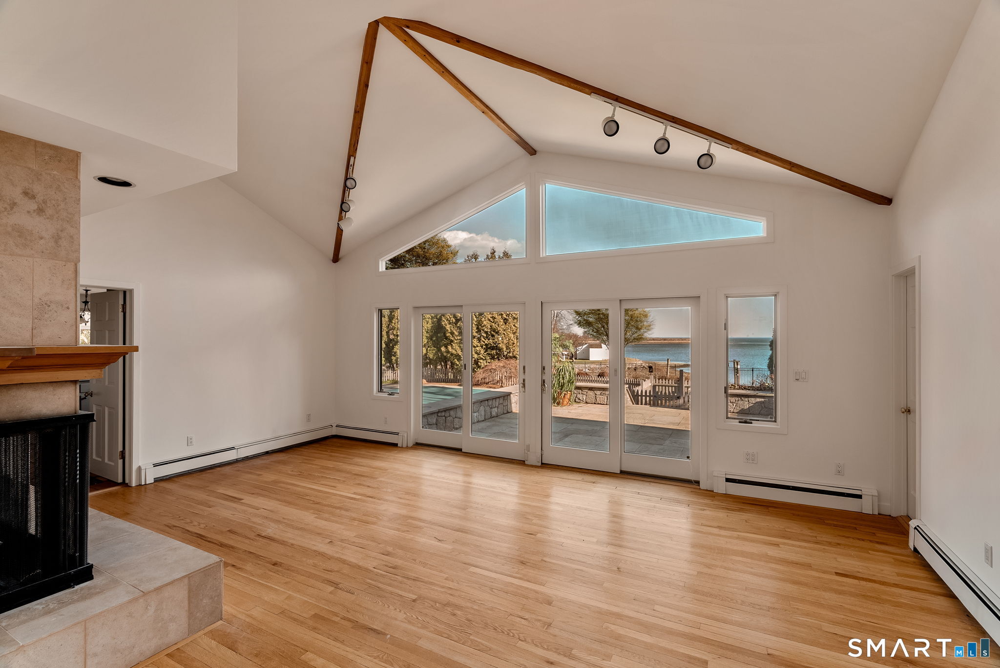 2 Judy Point Lane Westport, CT 06880 - Photo 20 of 27 a view of a livingroom with wooden floor and a fireplace