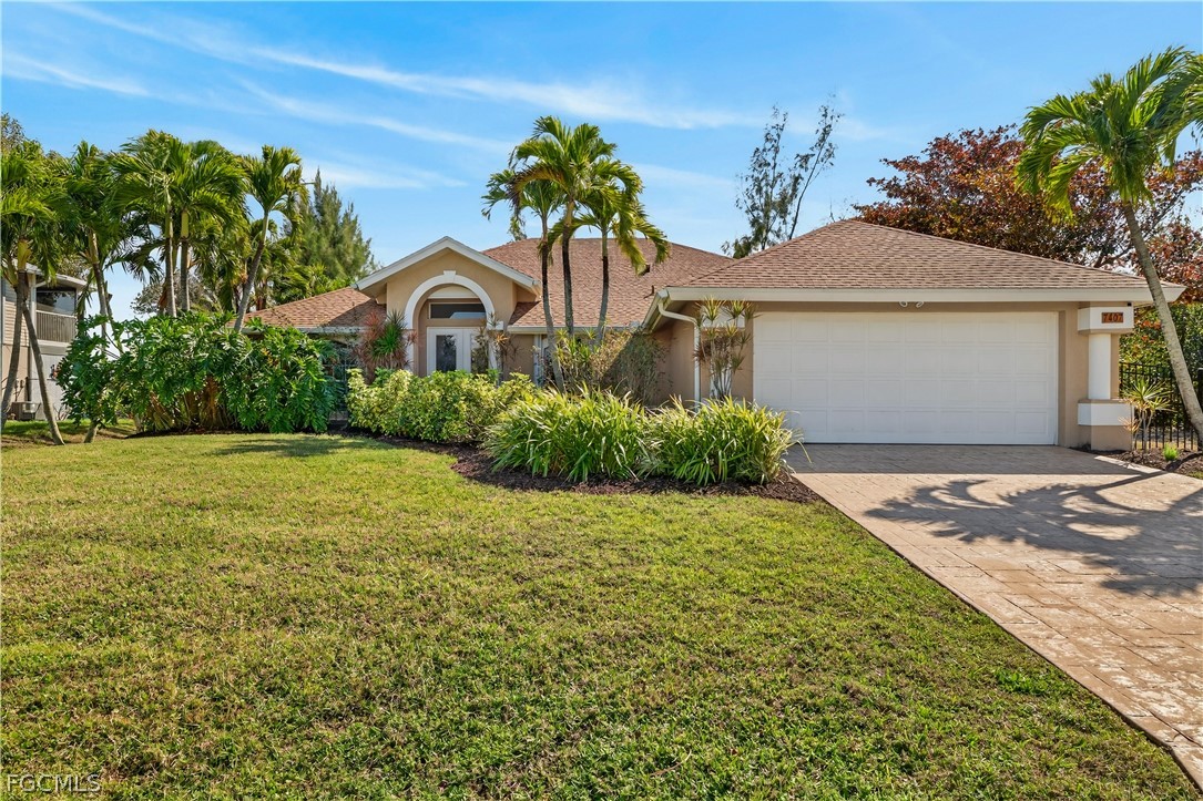 7407 Cobb Road Bokeelia, FL 33922 - Photo 2 of 41 a front view of a house with garden