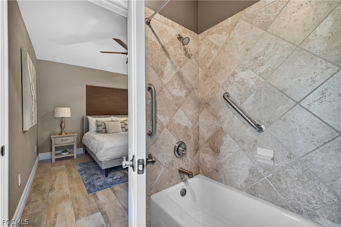 7407 Cobb Road Bokeelia, FL 33922 - Photo 25 of 41 a bathroom with a tub sink a mirror and a shower