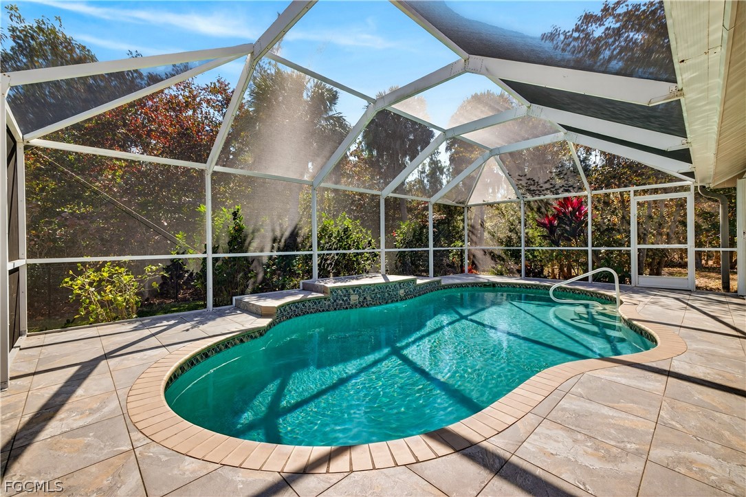 7407 Cobb Road Bokeelia, FL 33922 - Photo 29 of 41 a view of a swimming pool with a garden and plants