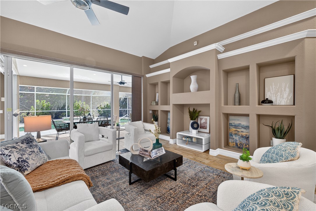 7407 Cobb Road Bokeelia, FL 33922 - Photo 6 of 41 a living room with furniture fireplace and a large window