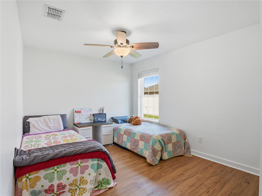 12724 Carpenter Lane Rhome, TX 76078 - Photo 19 of 37 Bright room featuring wood-finish flooring and a ceiling fan