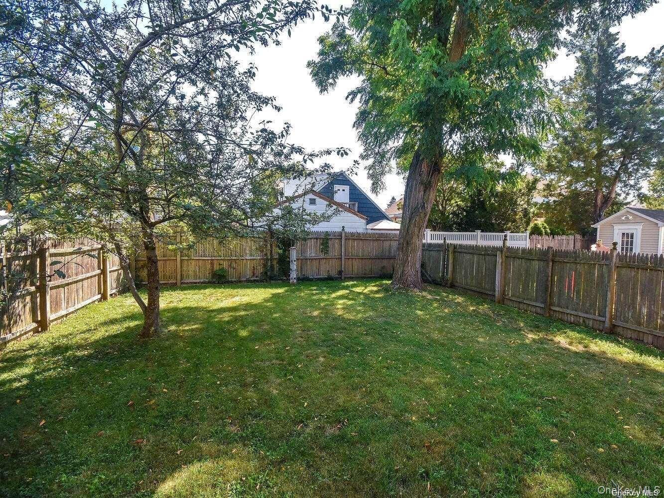 34 Firwood Road, Unit B Port Washington, NY 11050 - Photo 22 of 25 a view of a house with a yard