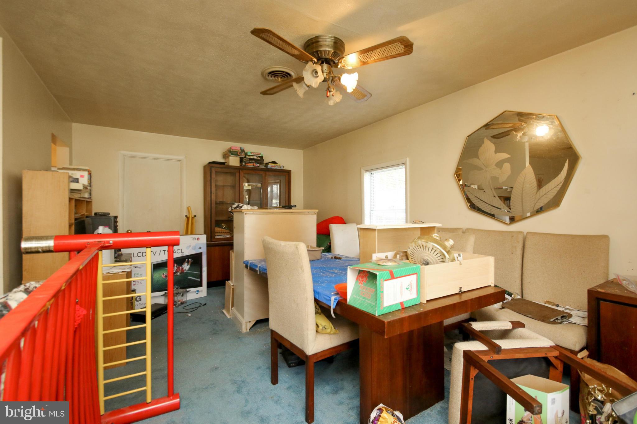 8183 Hog Neck Road Pasadena, MD 21122 - Photo 11 of 29 a living room with furniture and a clock