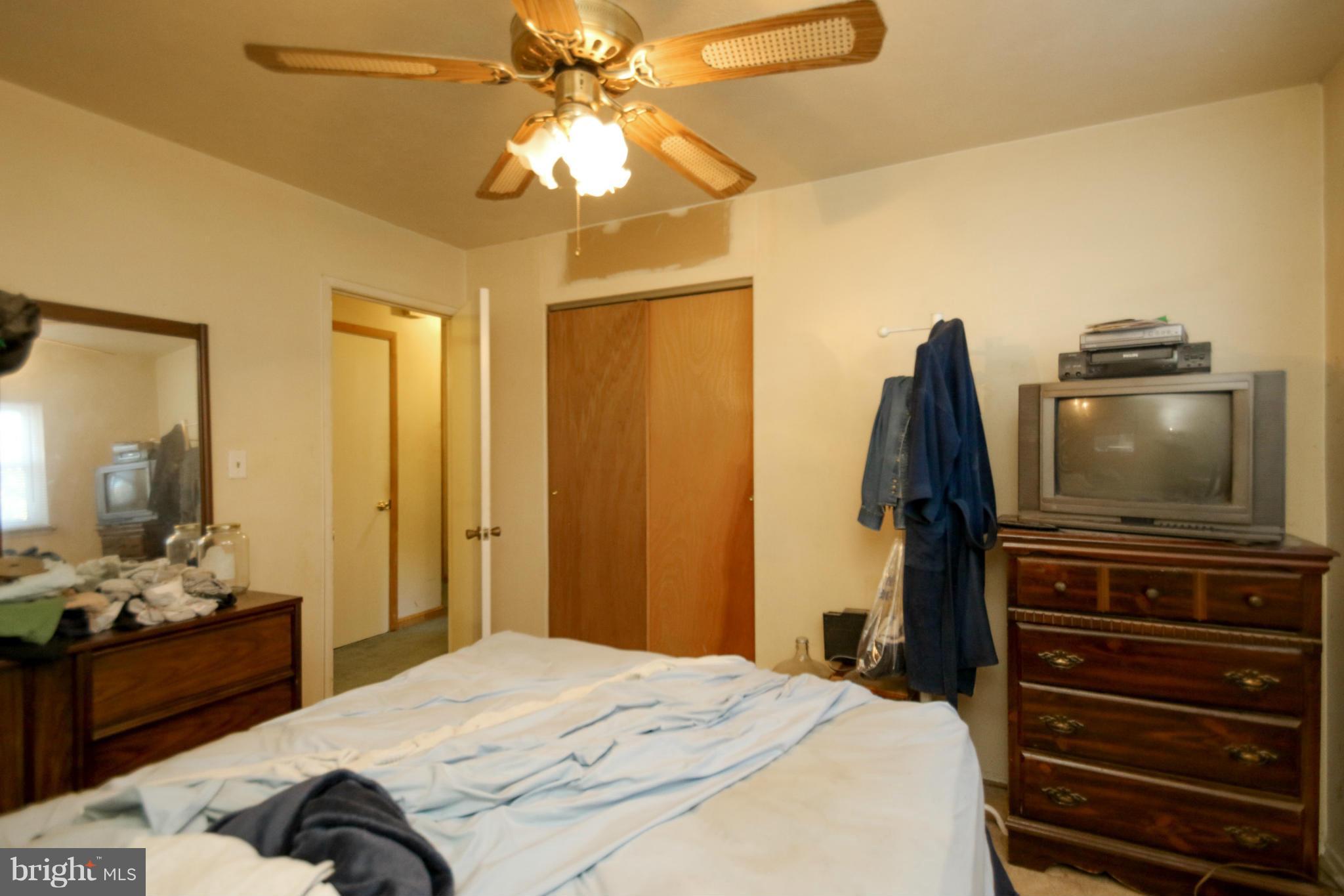 8183 Hog Neck Road Pasadena, MD 21122 - Photo 13 of 29 a bedroom with a bed and a flat screen tv