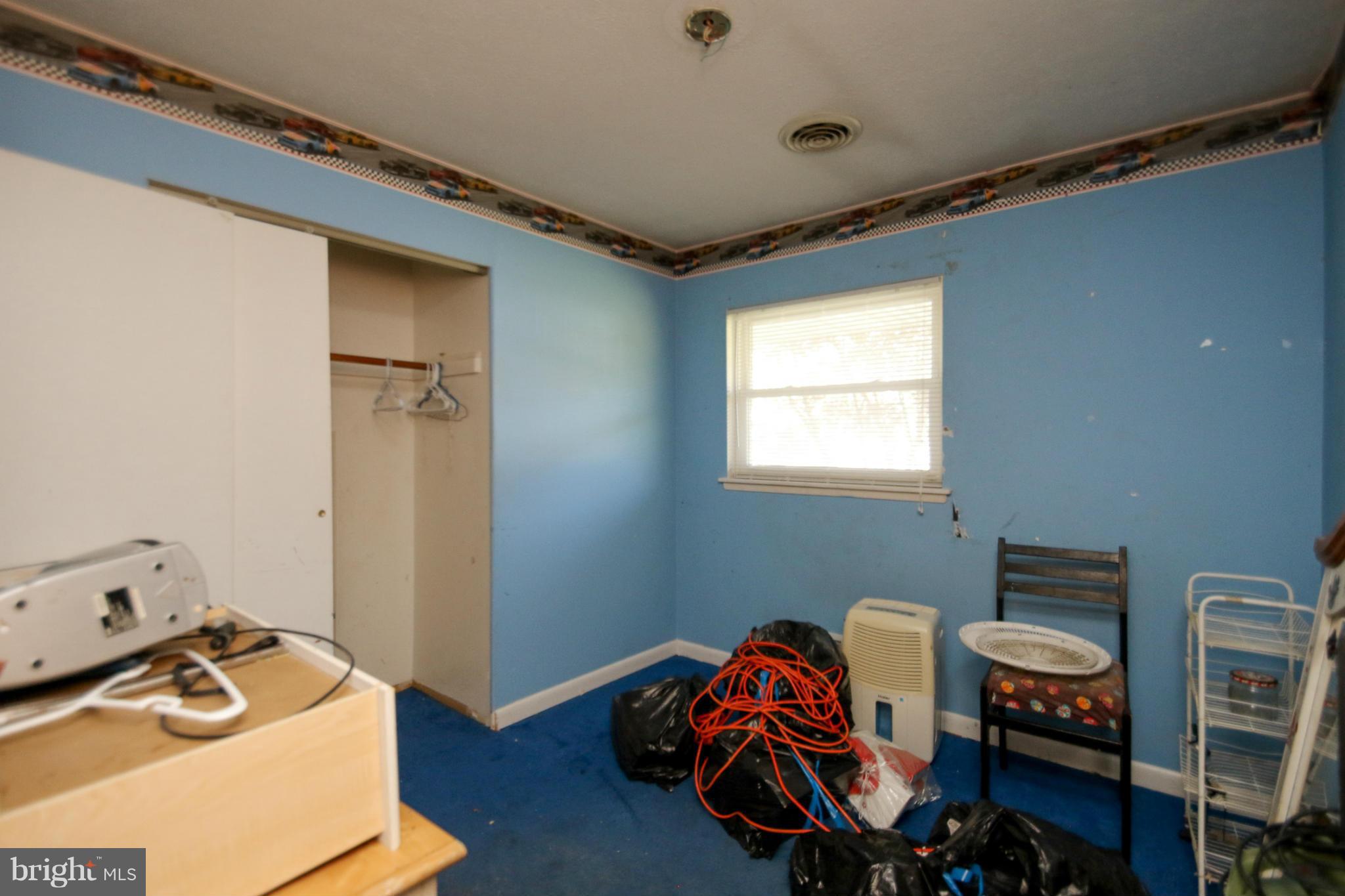 8183 Hog Neck Road Pasadena, MD 21122 - Photo 14 of 29 a bedroom with a bed and a window