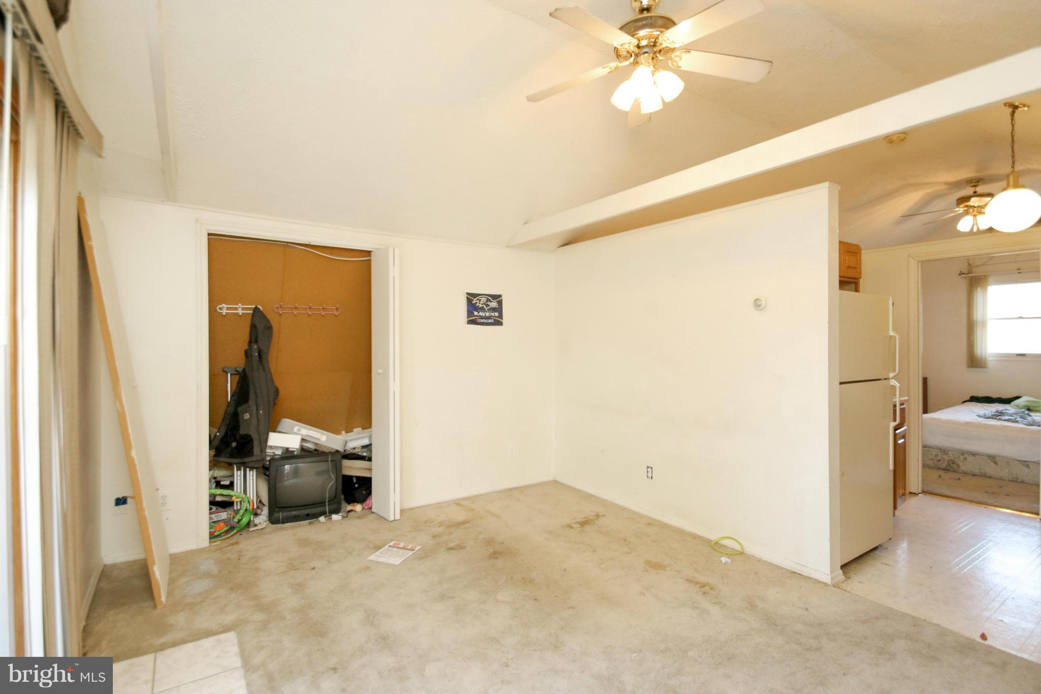 8183 Hog Neck Road Pasadena, MD 21122 - Photo 22 of 29 a view of a livingroom with a staircase and a ceiling fan