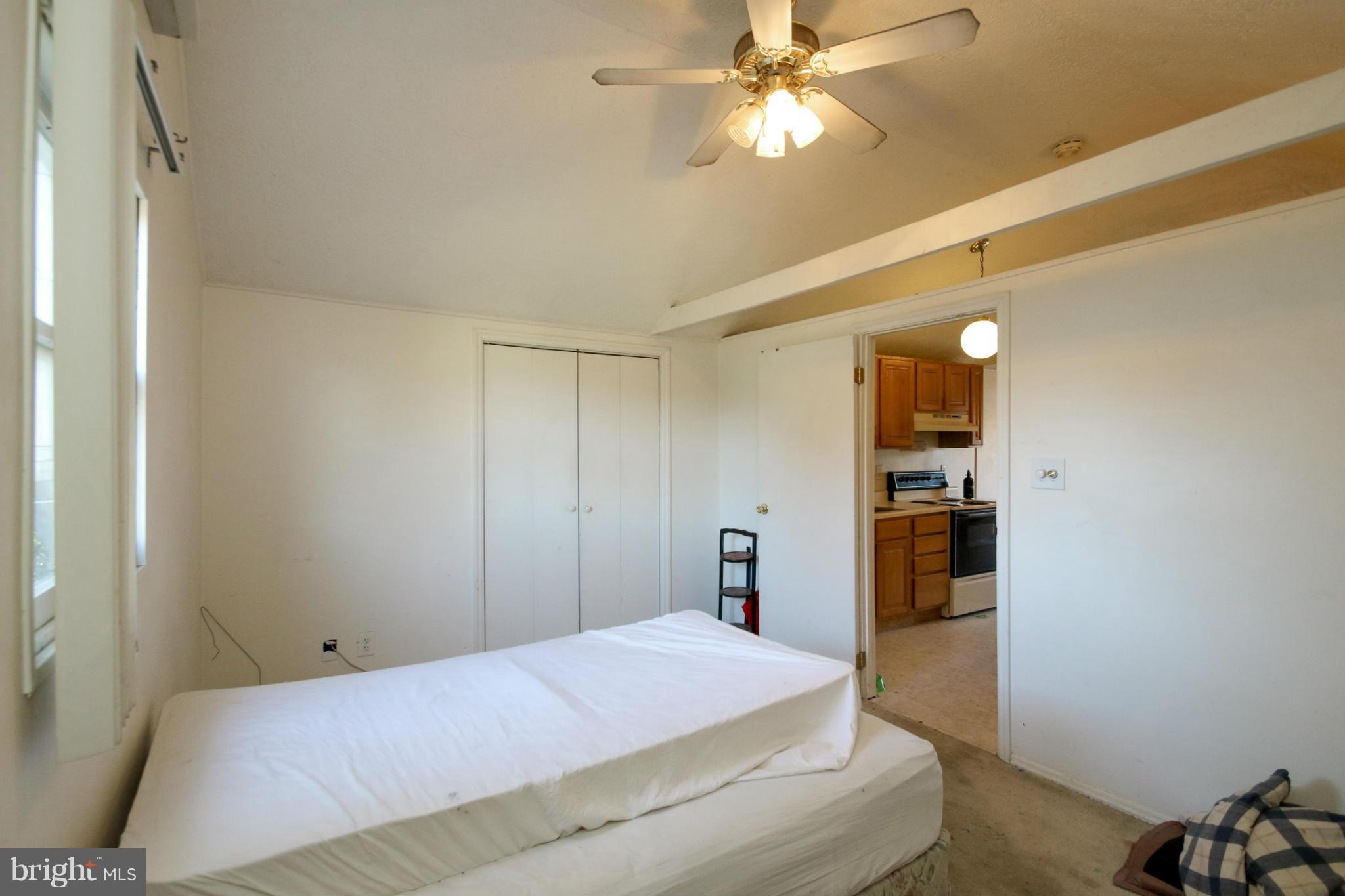 8183 Hog Neck Road Pasadena, MD 21122 - Photo 26 of 29 a bedroom with a bed and a chandelier