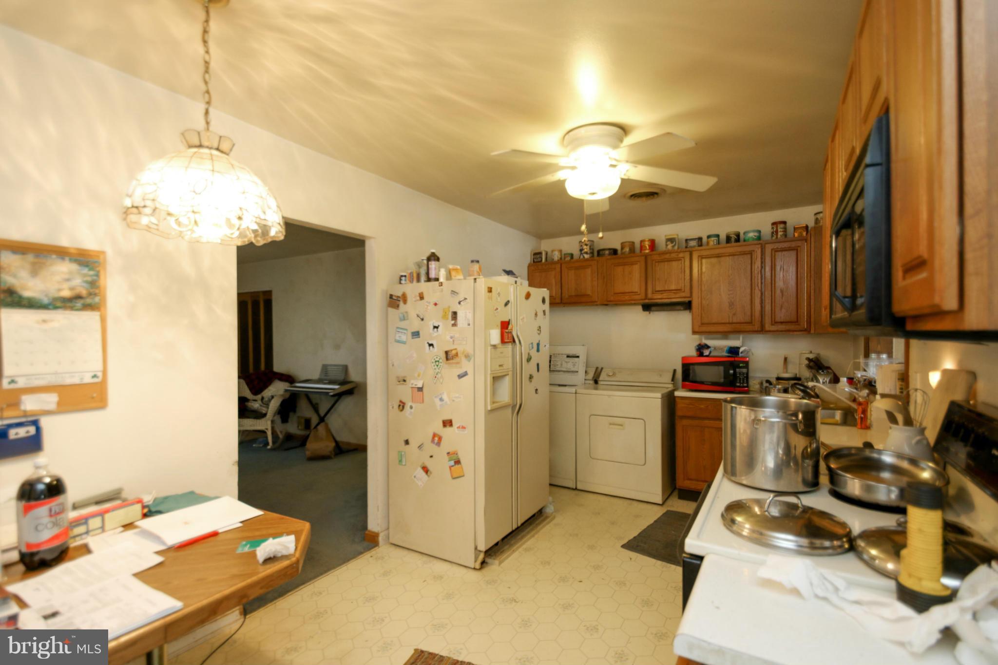 8183 Hog Neck Road Pasadena, MD 21122 - Photo 5 of 29 a kitchen with refrigerator and cabinets