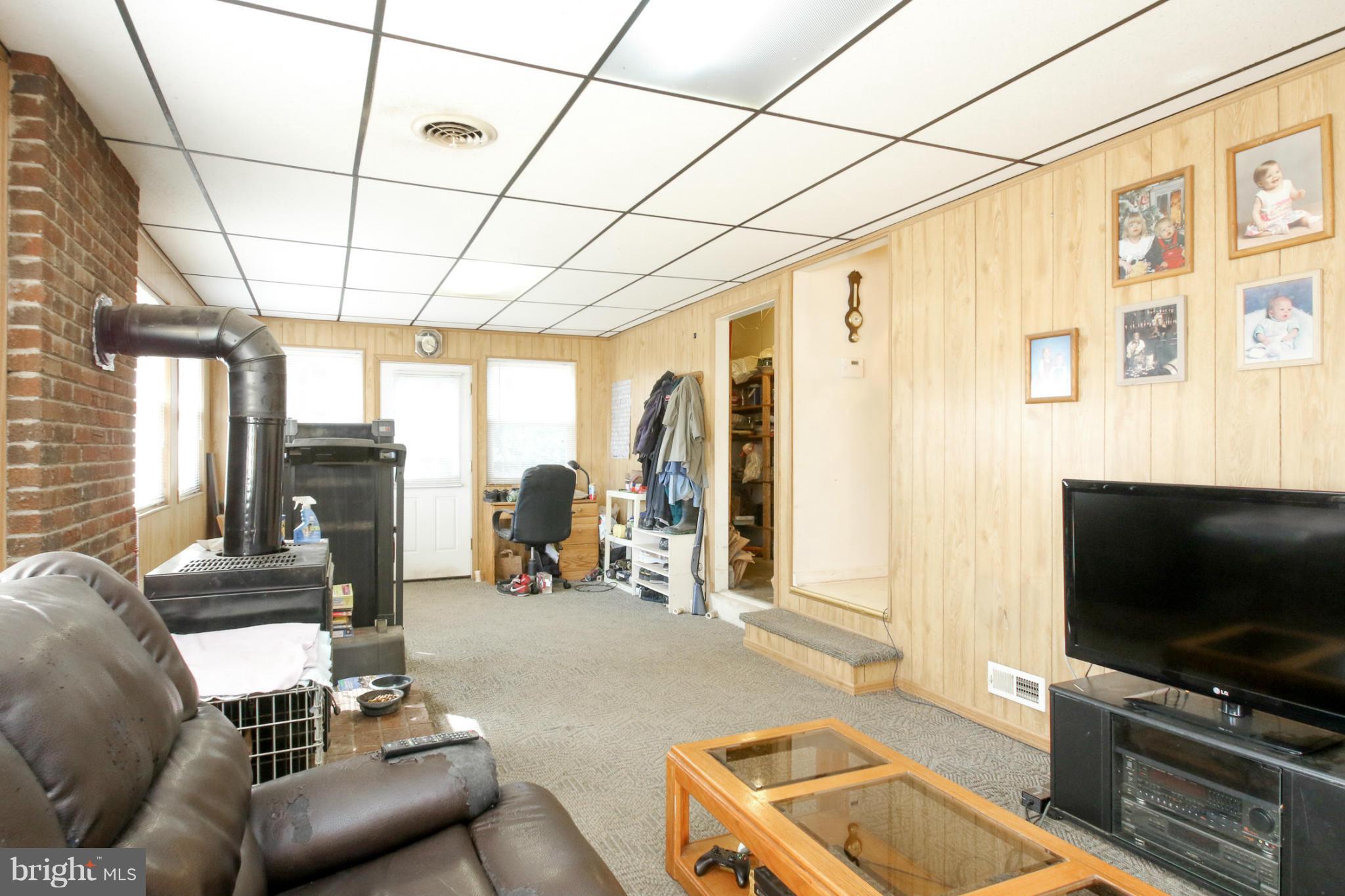8183 Hog Neck Road Pasadena, MD 21122 - Photo 7 of 29 a living room with furniture and a flat screen tv