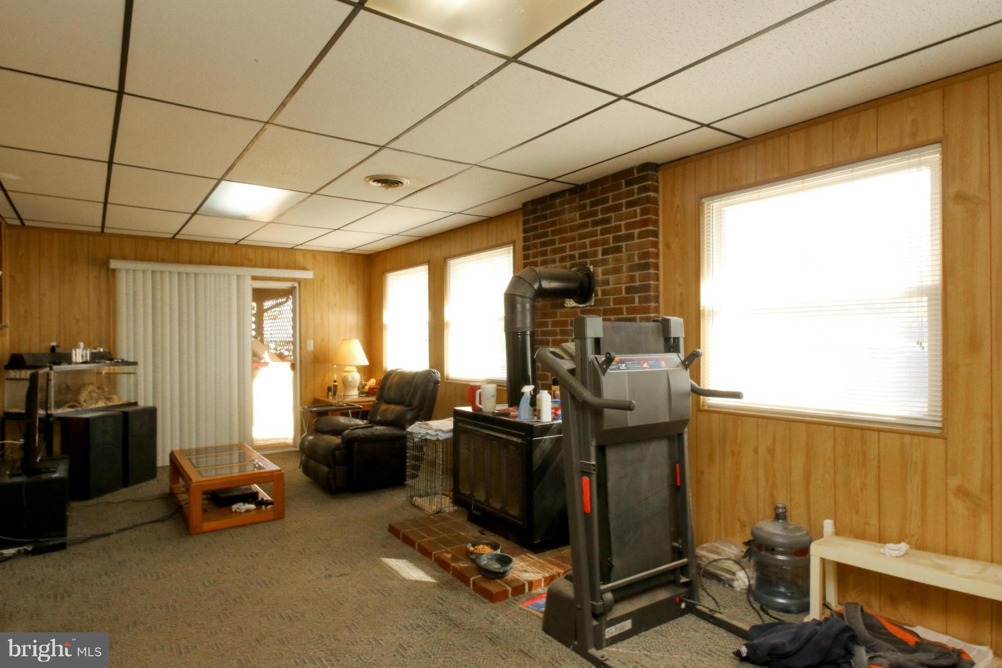 8183 Hog Neck Road Pasadena, MD 21122 - Photo 8 of 29 a room with gym equipment and a large window