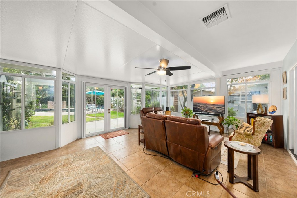 5180 Stonewood Drive Riverside, CA 92506 - Photo 11 of 31 a living room with furniture a flat screen tv and a floor to ceiling window