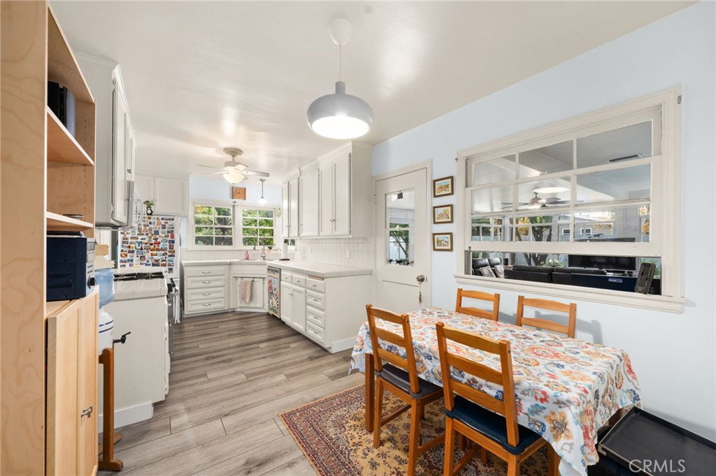 5180 Stonewood Drive Riverside, CA 92506 - Photo 15 of 31 a kitchen with stainless steel appliances kitchen island granite countertop a table chairs and a refrigerator