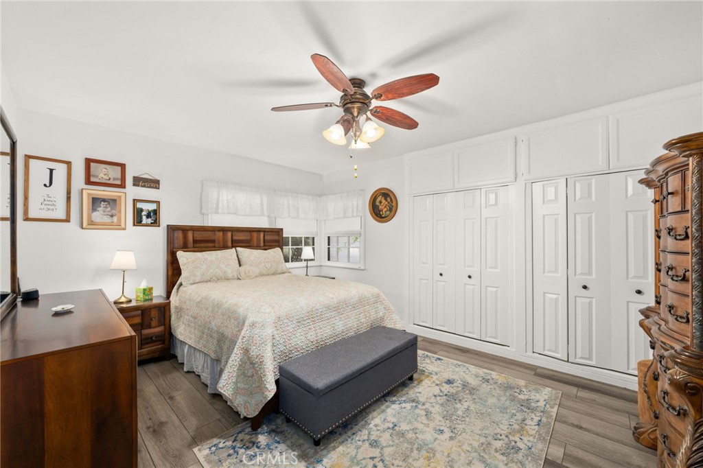 5180 Stonewood Drive Riverside, CA 92506 - Photo 18 of 31 a bedroom with a bed and a chandelier