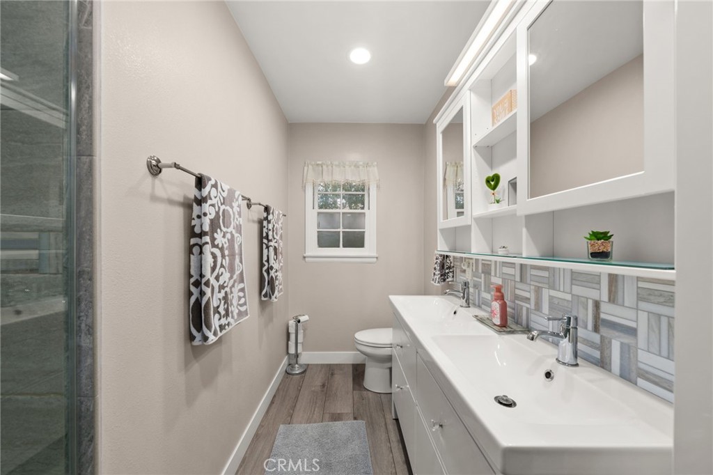 5180 Stonewood Drive Riverside, CA 92506 - Photo 21 of 31 a bathroom with a sink mirror and toilet