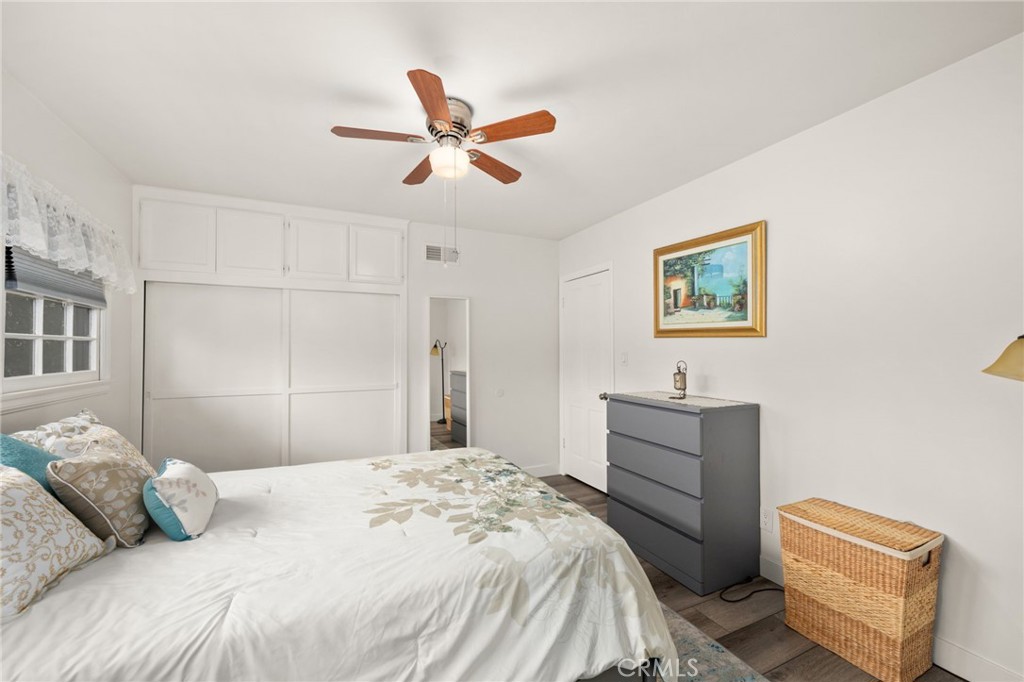 5180 Stonewood Drive Riverside, CA 92506 - Photo 23 of 31 a bedroom with a bed and a chandelier