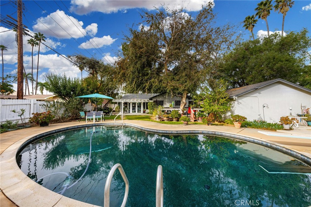 5180 Stonewood Drive Riverside, CA 92506 - Photo 30 of 31 a swimming pool with outdoor seating and yard