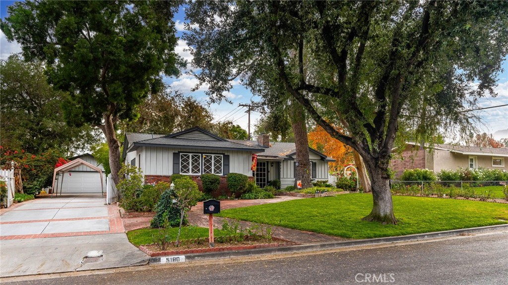 5180 Stonewood Drive Riverside, CA 92506 - Photo 3 of 31 a front view of a house with a garden