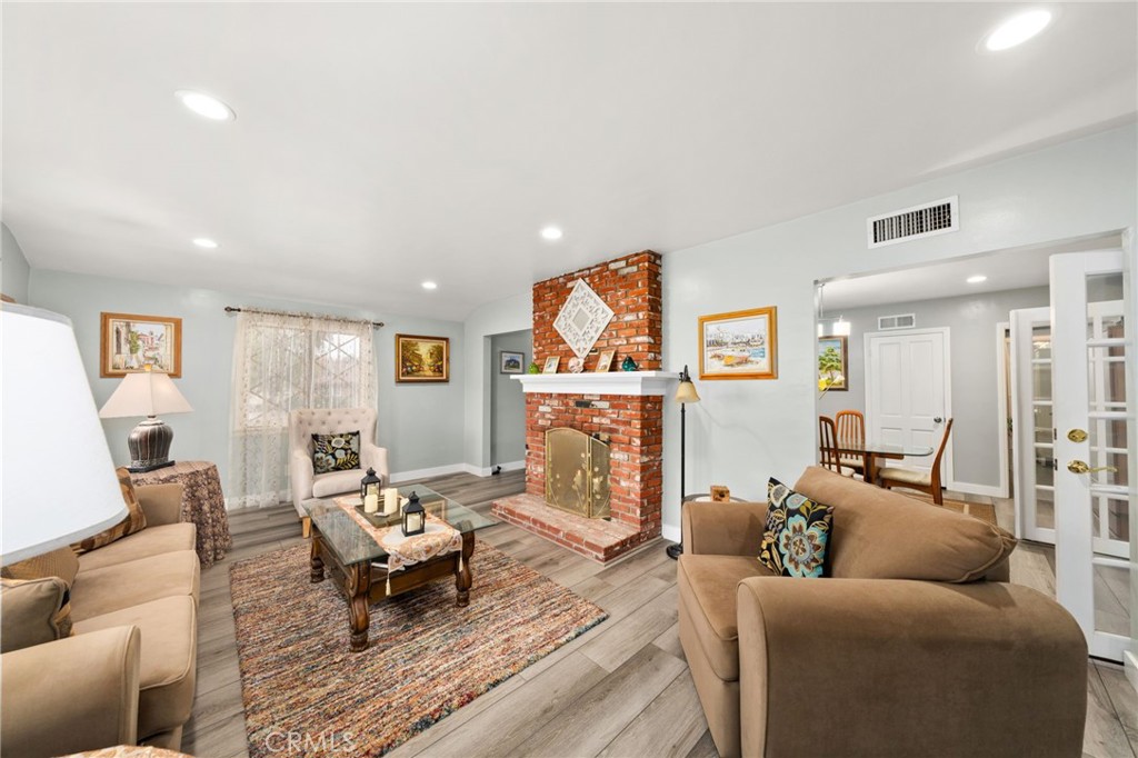 5180 Stonewood Drive Riverside, CA 92506 - Photo 6 of 31 a living room with furniture a fireplace and a flat screen tv