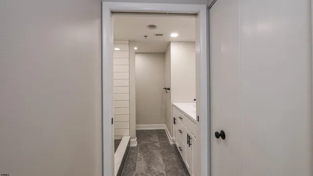 a bathroom with a double vanity sink a shower and a mirror