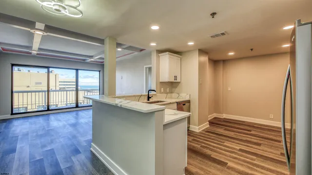 a view of a kitchen with cabinets and wooden floor