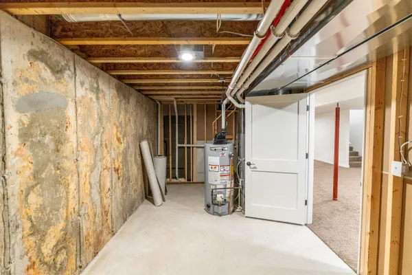 a kitchen with a white stove a sink and dishwasher with wooden floor