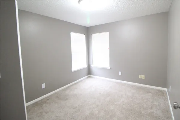 a view of staircase with white walls and a window