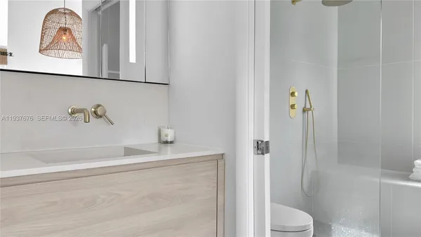 a bathroom with a toilet and a shower