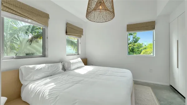 a bedroom with bed and window