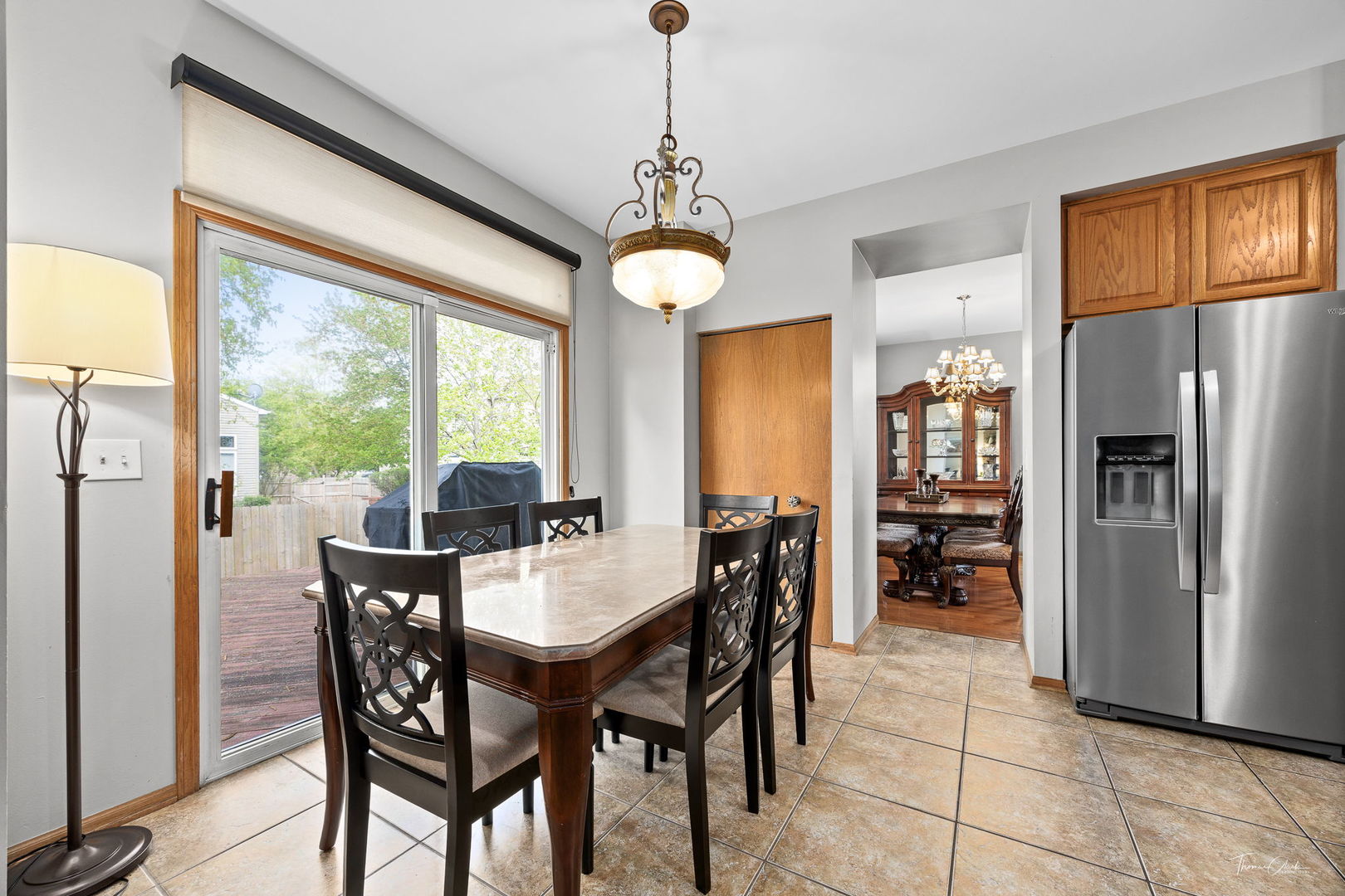 1913 Apple Valley Road Bolingbrook, IL 60490 - Photo 8 of 32 a dining room with furniture a chandelier and window