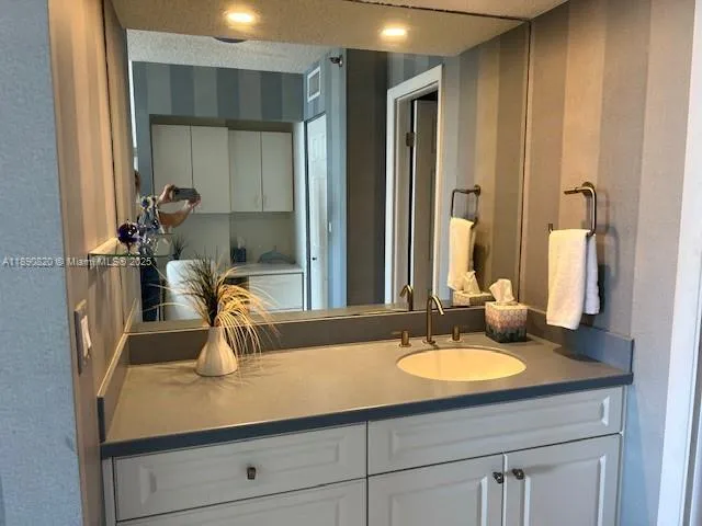 a bathroom with a sink double vanity and a mirror