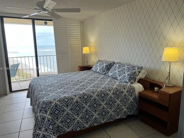 a bedroom with a bed and a lamp next to a window