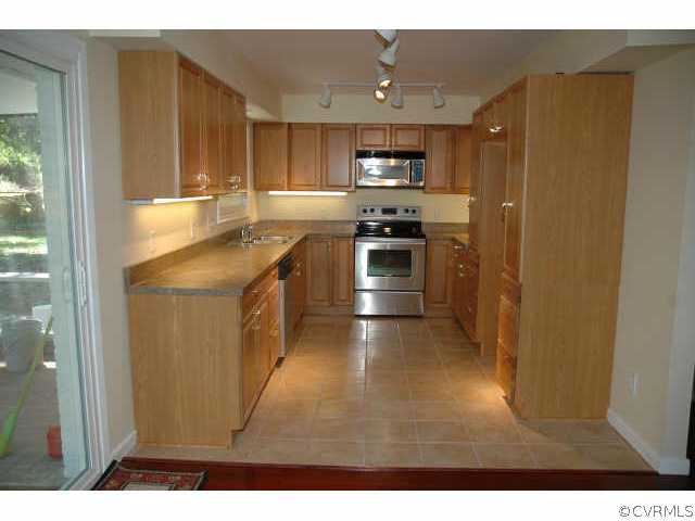 1321 Andover Road Richmond, VA 23229 - Photo 3 of 10 a kitchen with stainless steel appliances a sink stove and refrigerator