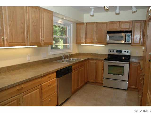 1321 Andover Road Richmond, VA 23229 - Photo 4 of 10 a kitchen with stainless steel appliances a stove sink and microwave