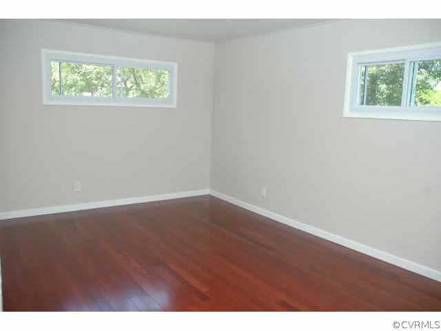 1321 Andover Road Richmond, VA 23229 - Photo 6 of 10 an empty room with wooden floor and windows