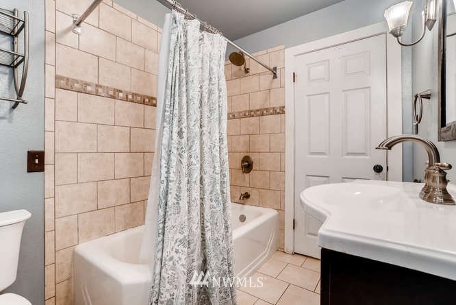 832 Southwest 4th Place Renton, WA 98057 - Photo 15 of 25 a bathroom with a sink a toilet and shower