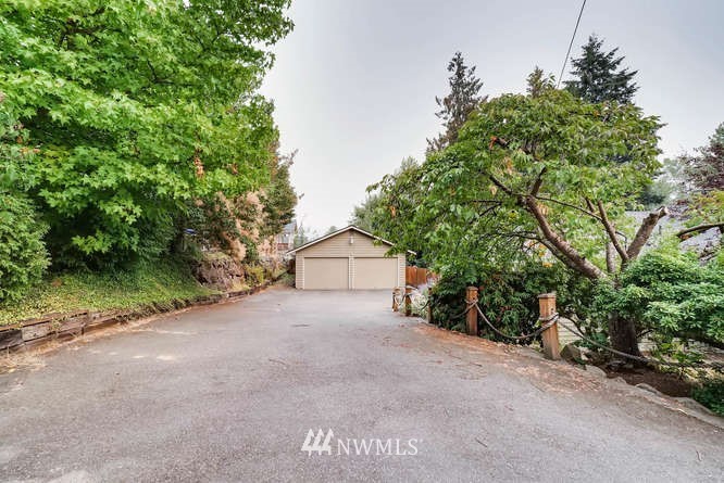 832 Southwest 4th Place Renton, WA 98057 - Photo 25 of 25 a big house with large trees and plants