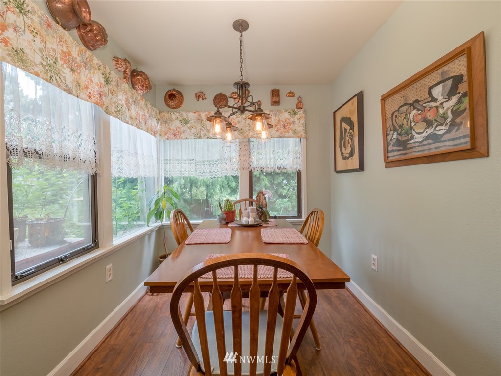 832 Southwest 4th Place Renton, WA 98057 - Photo 7 of 25 a dining room with furniture a chandelier and wooden floor