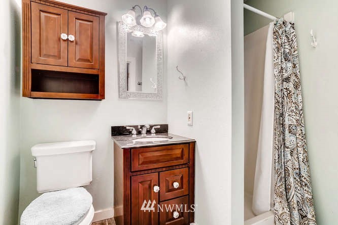 832 Southwest 4th Place Renton, WA 98057 - Photo 8 of 25 a bathroom with a toilet a sink and a mirror