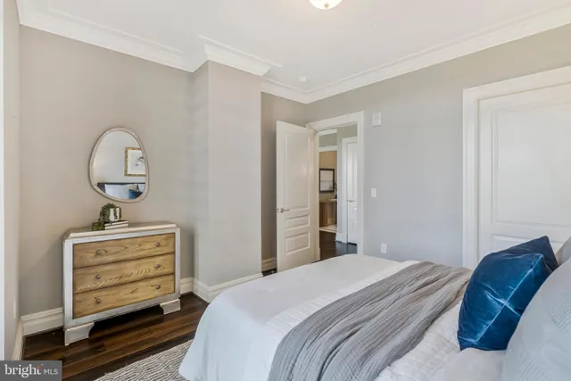 a bathroom with a toilet a sink a vanity and mirror