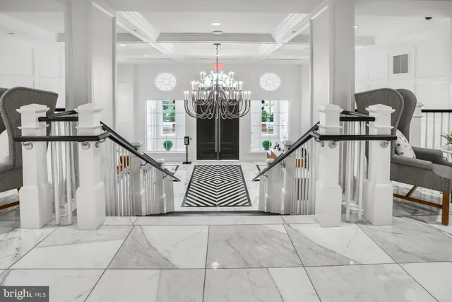 a view of a livingroom with furniture and a floor to ceiling window