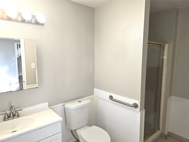 a white toilet sitting next to a bathroom sink